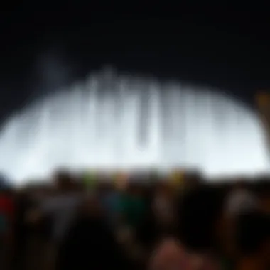Nighttime Enjoyment of Dubai Fountain A nighttime view of the fountain with a crowd enjoying the show